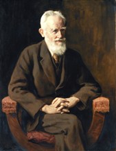 An elderly man with a beard sits in an armchair and looks thoughtful. portrait of George Bernard