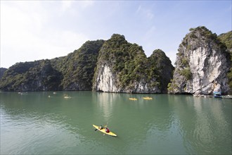 Kayakers and the karst rocks in Lan Ha Bay, Halong Bay, Vietnam, Asia