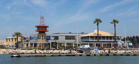 Harbour view with buildings and palm trees on a sunny day, Vilamoura, Faro, Algarve, Portugal,