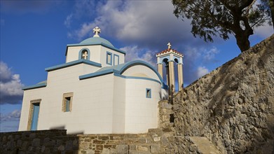 Saint Filimon Church, Greek church with blue domes and a tree under a cloudy sky, Colourful