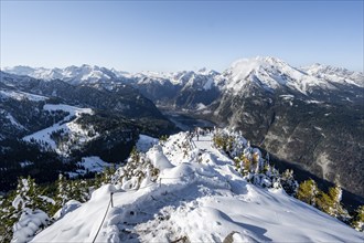 Hiking trail on the snow-covered summit of the Jenner with viewing platform in autumn, view of