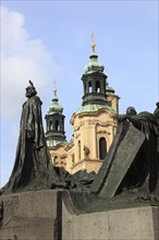 Jan Hus Monument on the Old Town Square and the towers of St Nicholas Church, Prague, Czech