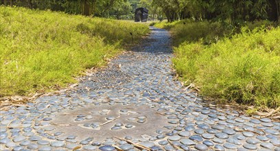 Garden path of decorative gray pebbles in botanical garden