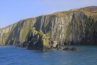 Sheer cliff vertical sedimentary rock strata, west coast Cape Clear Ireland, County Cork, Ireland,