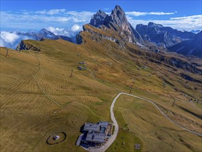 Sofie hut, behind the peaks Sas Rigais and Furchetta of the Geisler group, drone shot, Val Gardena,