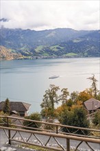 Tranquil landscape with lake, mountains and a boat in autumnal atmosphere, Lake Brienz,