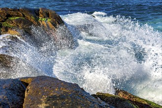 Sea water splashing and foam after wave crashes against the rock, Ipanema Beach, Rio de Janeiro,