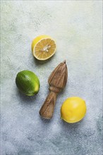 Wooden citrus reamer, manual lemon juicer, made of acacia wood, with citrus fruits on the table,