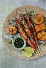 Langoustines on skewers, shrimp kebab, with fried corn, spices and herbs, homemade, no people