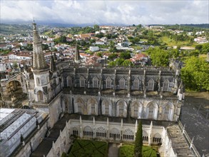 Aerial view of a Gothic cathedral with a magnificent tower and windows, an inner courtyard is