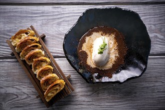 Ice cream dessert with milk and coffee on black bowl