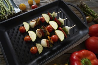 Brochette vegetable on grill pan with tomato onion pepper zucchini