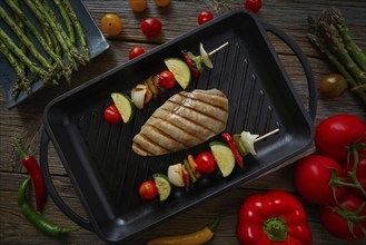 Grilled chicken breast with brochette vegetable on grill pan