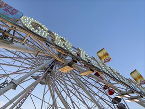 Ferris wheel, bottom view of a ferris wheel against the blue sky. San Diego County Fair,