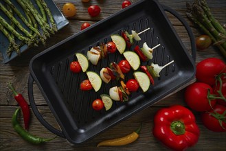 Brochette vegetable on grill pan with tomato onion pepper zucchini