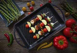 Brochette vegetable on grill pan with tomato onion pepper zucchini