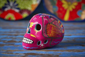 Mexican pink skull dia muertos crafts in Mexico of deaths day