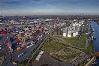 Commercial port with container terminal and oil tanks at the Rhine river in North Rhine-Westphalia,