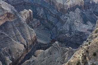 View from the Al Hayl mountain plateau into the rugged Wadi Nakhar of the Grand Canyon of Oman,