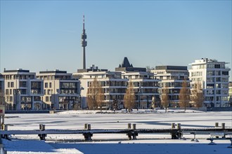 View of the snow-covered and frozen Phoenix Lake and the Florian television tower in Dortmund,