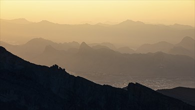 View from the mountain plateau Al Hayl into the valley, below the village of Ghul, behind in the