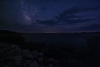 Clear starry sky over a dark coastal landscape at night, Milky Way, Lastovo, Neretva, Croatia,