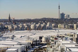 View of the snow-covered and frozen Phoenix Lake and the Florian television tower in Dortmund,