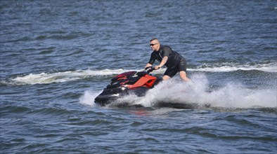 Man on jet ski, water scooter on Baltic Sea, Swinoujscie, Western Pomerania, Poland, Europe