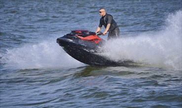 Man on jet ski, water scooter on Baltic Sea, Swinoujscie, Western Pomerania, Poland, Europe