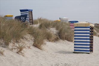 Several beach chairs in different colours on sandy dunes, Borkum, l North Sea, GERMANY