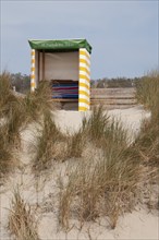 A beach chair surrounded by dunes in a quiet landscape, Borkum, l North Sea, GERMANY