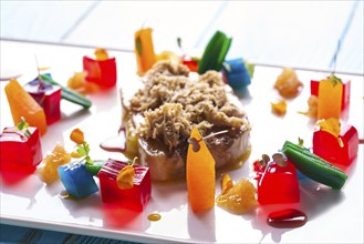 Foie slice with grated white truffle and colorful jelly decoration