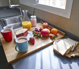 Breakfast in kitchen with coffee bread fruit juice and cake