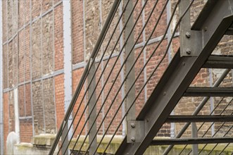 Close up of metal fire escape staircase on old brick wall building