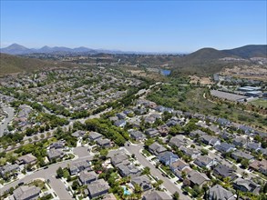 Aerial view of Carmel Mountain neighborhood with big mansions and mountain on the background in San