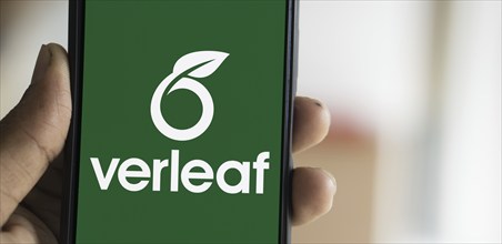 Overleaf logo is displayed on smartphone. Overleaf is a cloud-based LaTeX editor for scientific