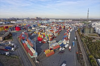 Commercial port with container terminal and oil tanks at the Rhine river in North Rhine-Westphalia,