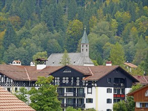 View over the roofs of Urfeld to St. Ulrich am Walchensee. Bavaria, Germany, Europe