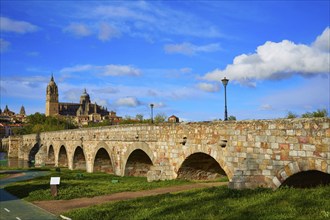 Salamanca skyline and roman bridge over Tormes river in Spain