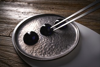 Molecular cuisine concept spheritions black jelly texture