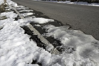 Snow on asphalt road hide the white lines