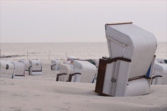 Single beach chair on empty beach with sea view in soft pastel colours, Borkum, North Sea, GERMANY