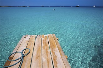 Formentera Ses Illetes beach pier Illetas with Ibiza background at balearic islands