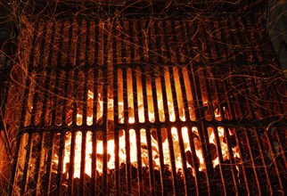 Bar-b-cue grill barbecue with red ashes and sparkles in fire