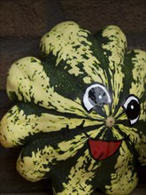 An eye-catching, painted ornamental pumpkin with a cheerful face, borken, münsterland, germany