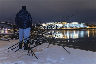 Night Fishing Fisherman in Winter night. Night Fishing, Winter fishing. Carp Rods, Night reflection