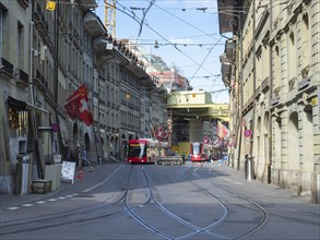 Situation in the historic city centre of Berne, Switzerland. A tramcar and a trolley bus moving