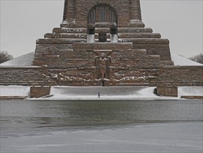 Lonely hiker at the wintry Völkerschlachtdenkmal. Leipzig, Saxony, Germany, Europe