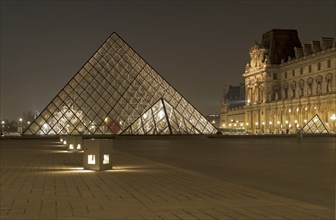 Paris, France, March 15, 2011: Glass pyramids in the Louvre late in the evening, Europe