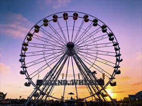 Ferris wheel, bottom view of a Ferris wheel during sunset. San DIego County Fair, California, USA.